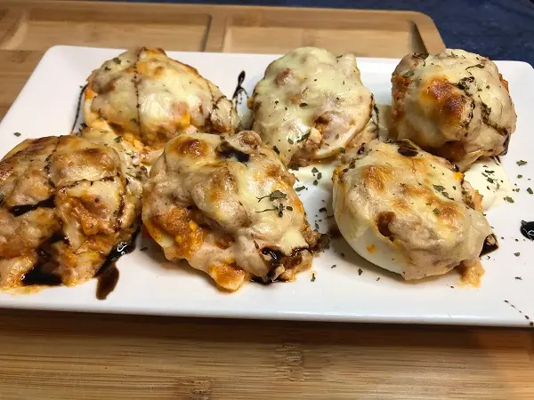 Huevos rellenos de atún con tomate y maíz. Gratinados al horno y servidos con vinagre balsámico.